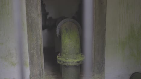 old water pipes overgrown with moss and corrosion