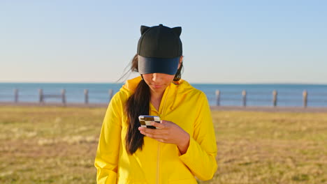 Teenager,-girl-and-phone-selfie-on-beach-holiday