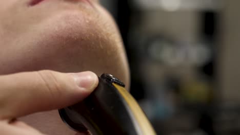 close-up of a man getting his beard trimmed at a barber shop