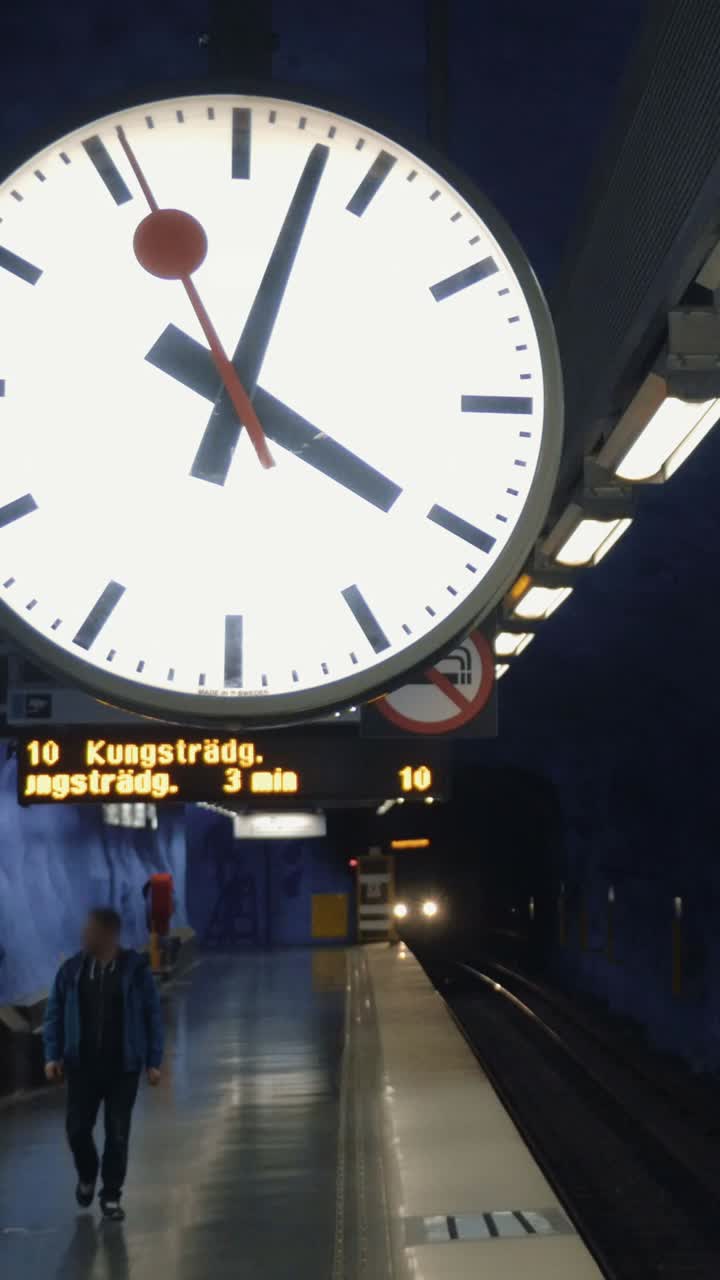 Subway station with clock and train