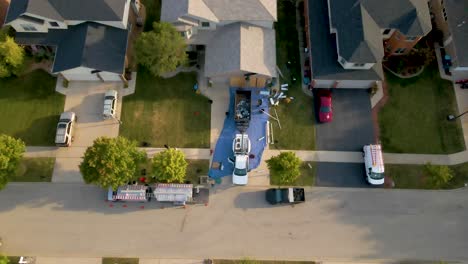 establishing aerial drone view of suburban homes by a serene lake in illinois, showcasing a peaceful neighborhood with well-maintained lawns and picturesque waterfront scenery