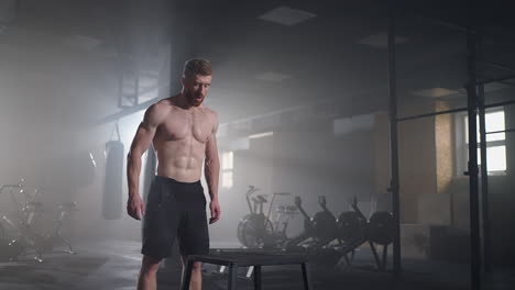 Athlete-gave-exercise.-Jumping-on-the-box.-Strong-male-athlete-jumping-on-cube-closeup.-Tracking-shot-of-fit-sportswoman-jumping-on-cube-during-intense-crossfit-workout-in-gym