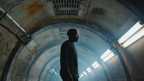 man walking through a mysterious dark tunnel