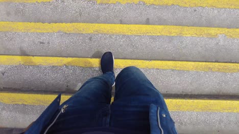 person walking up concrete stairs