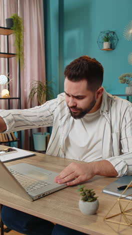 displeased sad businessman using laptop loss game fail computer virus error bad news at home office