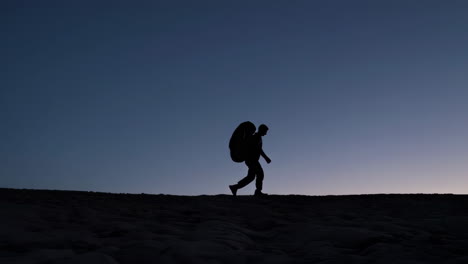 silhouette of a hiker in the desert at sunset