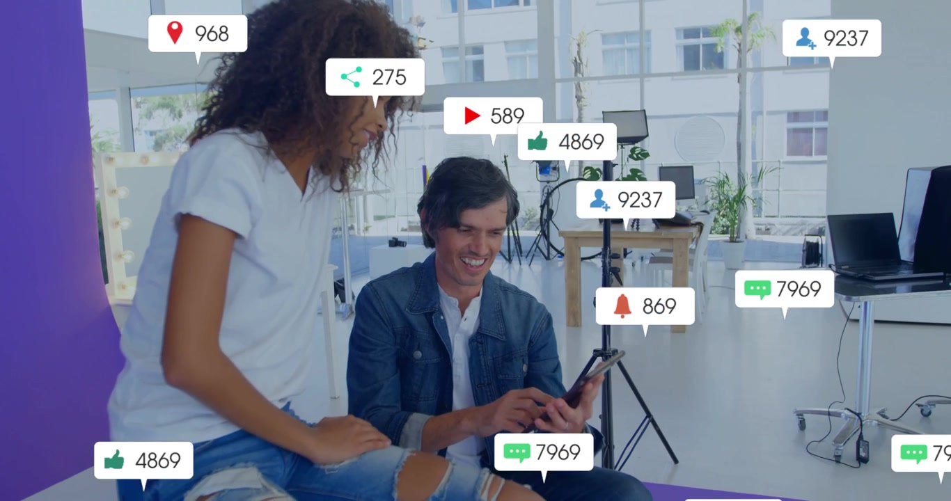 Creatives tapping phone and leaning on purple mat, creating rising marketing bubbles around them