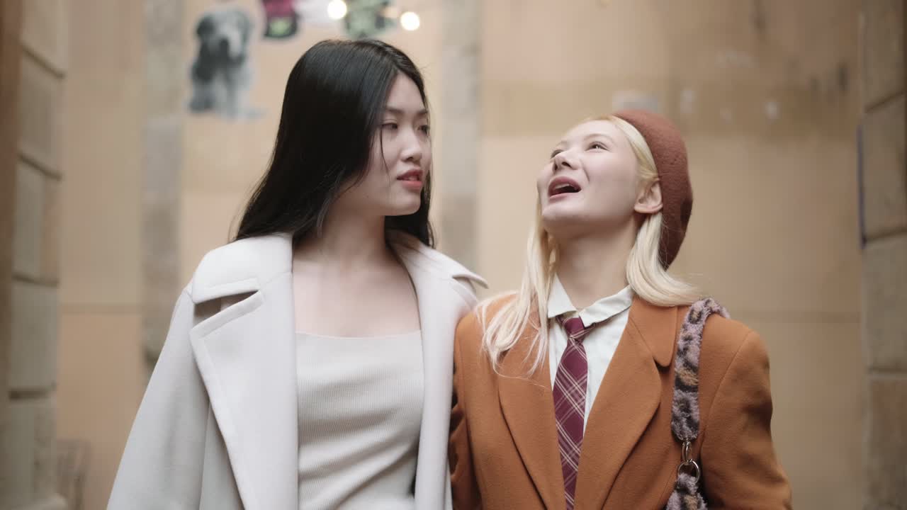 Two stylish women walking together in the city