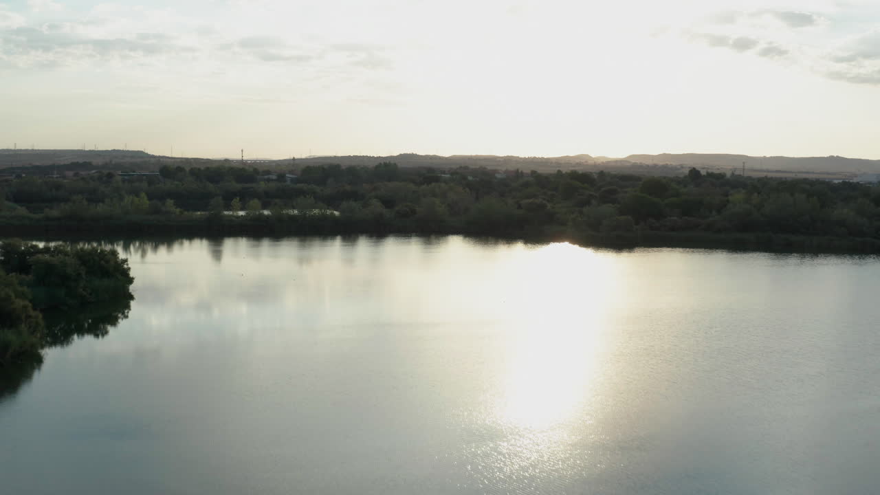 Laguna El Picon De Los Conejos near Madrid in Spain. Sun reflection on water. Aerial drone shot.