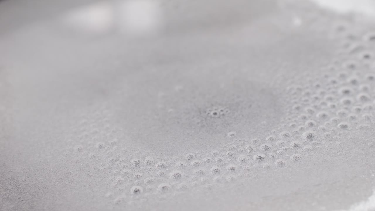 Close up of boiling sugar with bubbles turns into caramel, caramelization, chef cooking dessert in cafe, restaurant pastry food.