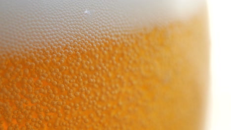 amazing closeup of a beer glass that is being filled up with more beer