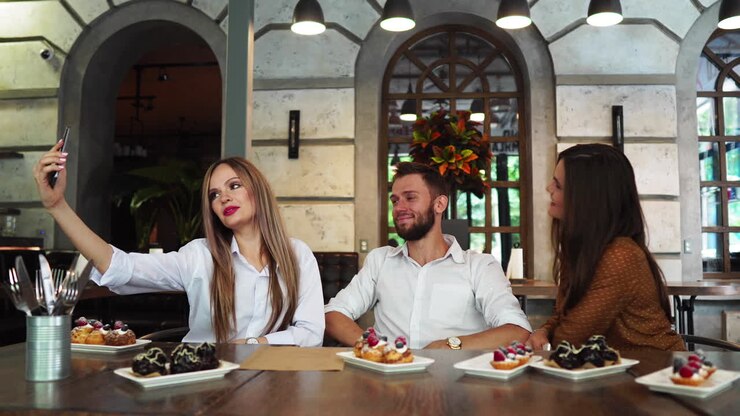 Cheerful multiracial friends taking selfie in pizzeria.