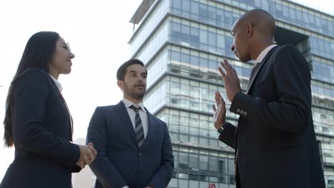 business people meeting and talking on street