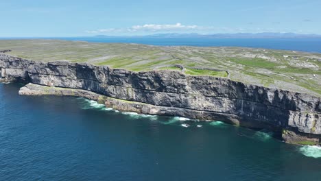 drone reveal of the high sea cliffs at dun angus on the northern side of inis more aran islands west of ireland