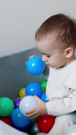 baby playing in a ball pit