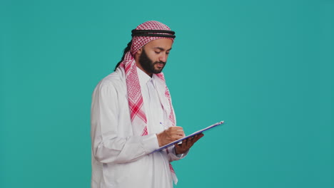 Arab-person-writing-letter-on-files