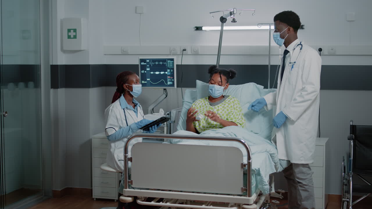 Team of doctors doing consultation with woman during pandemic