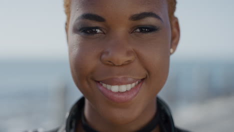 close up portrait successful young african american woman smiling enjoying independent lifestyle stylish black female student looking happy on seaside ocean background slow motion
