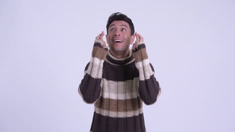 young handsome hispanic man ready for winter