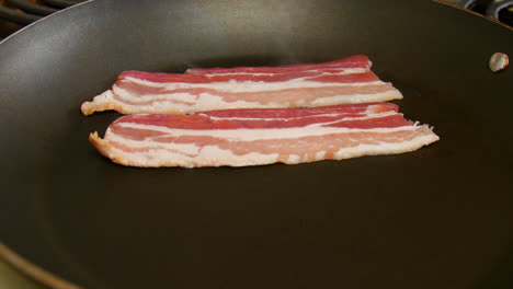 Cooking-Strips-of-Bacon-on-the-Stove