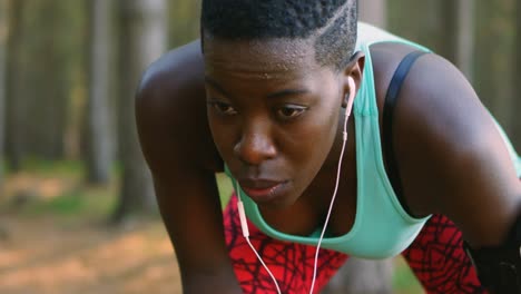 female jogger relaxing after jogging in the forest 4k