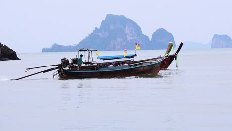 a boat travels across calm waters in krabi