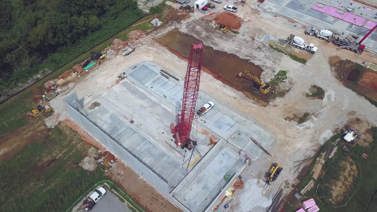 Aerial orbital view from above crane on construction site