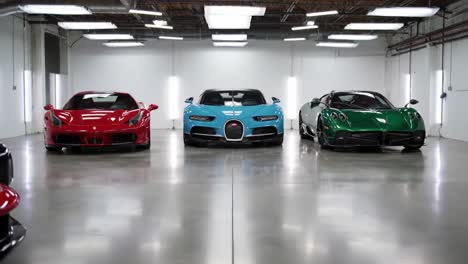 a stunning display of luxury supercars: captivating red, blue, and green models showcase exquisite design and engineering in a sleek modern environment