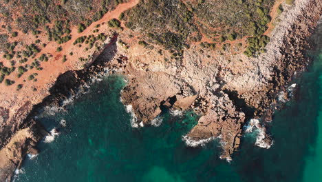 AERIAL:-Looking-down-on-the-orange-coastline-and-blue-waters-in-the-Algarve-Portugal