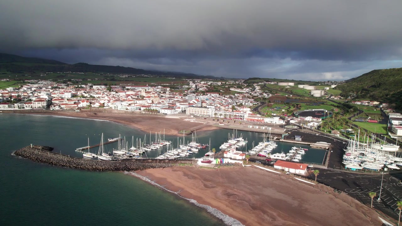 Wide aerial view over Praia da Vitória marina with moored sailboats and yachts