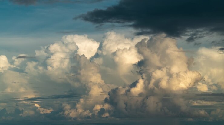 Dramatic cumulonimbus clouds form above ocean during dusk, timelapse