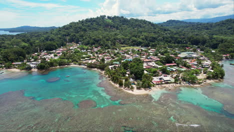 a wide establishing aerial of tropical beaches and lush mountains around the beach town of puerto viejo, a popular tourist destination on the caribbean coast of costa rica.