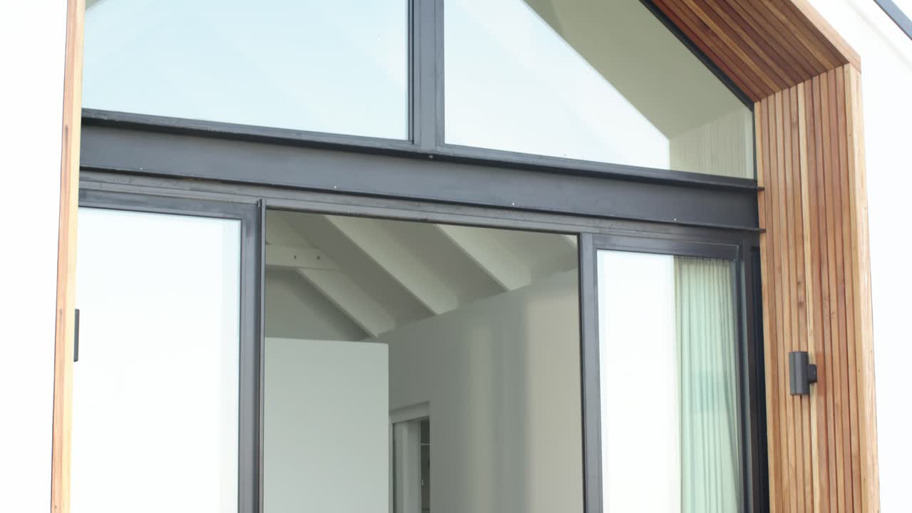 En reproducción, la cámara se inclina hacia arriba y se aleja desde una puerta de cristal hasta el vértice del tejado, mostrando la arquitectura.