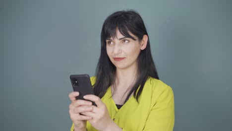 happy woman texting on the phone. smiling.