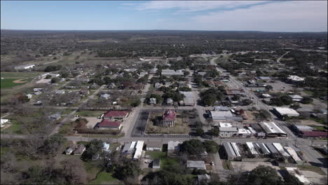 aerial shot over the historic courthouse in johnson city, texas, dolly backwards