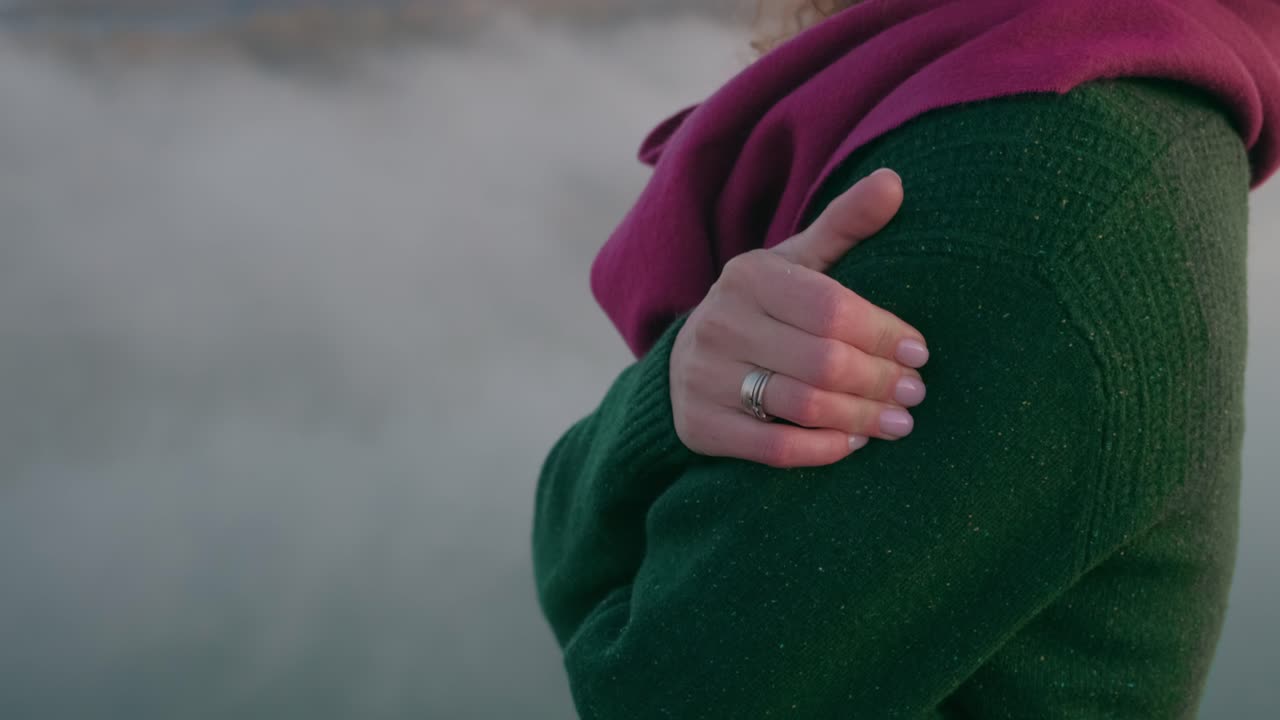 Woman in a Green Sweater and Scarf