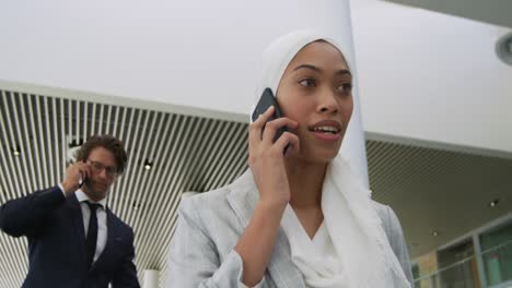 Young-business-people-on-an-escalator-in-a-modern-building