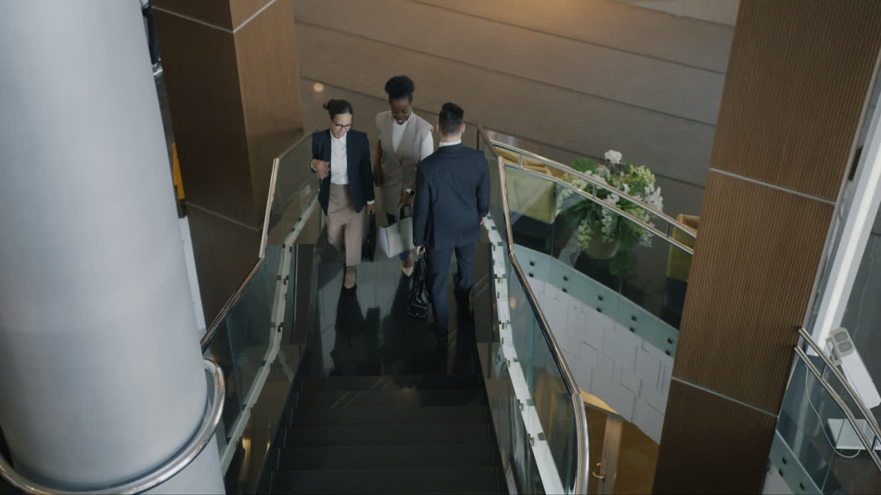 Business People Walking Upstairs in Modern Office