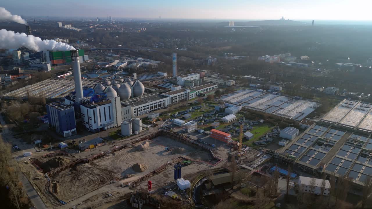 Wastewater treatment plant purifying urban water showing sedimentation tanks, aeration tanks and clarifiers. Perfect aerial view flight panorama orbit drone