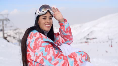 gorgeous young woman in ski clothes and goggles