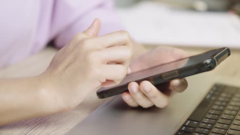 a young businessman is taking a video conference and touchscreen with customers via a smart phone connected to the internet.