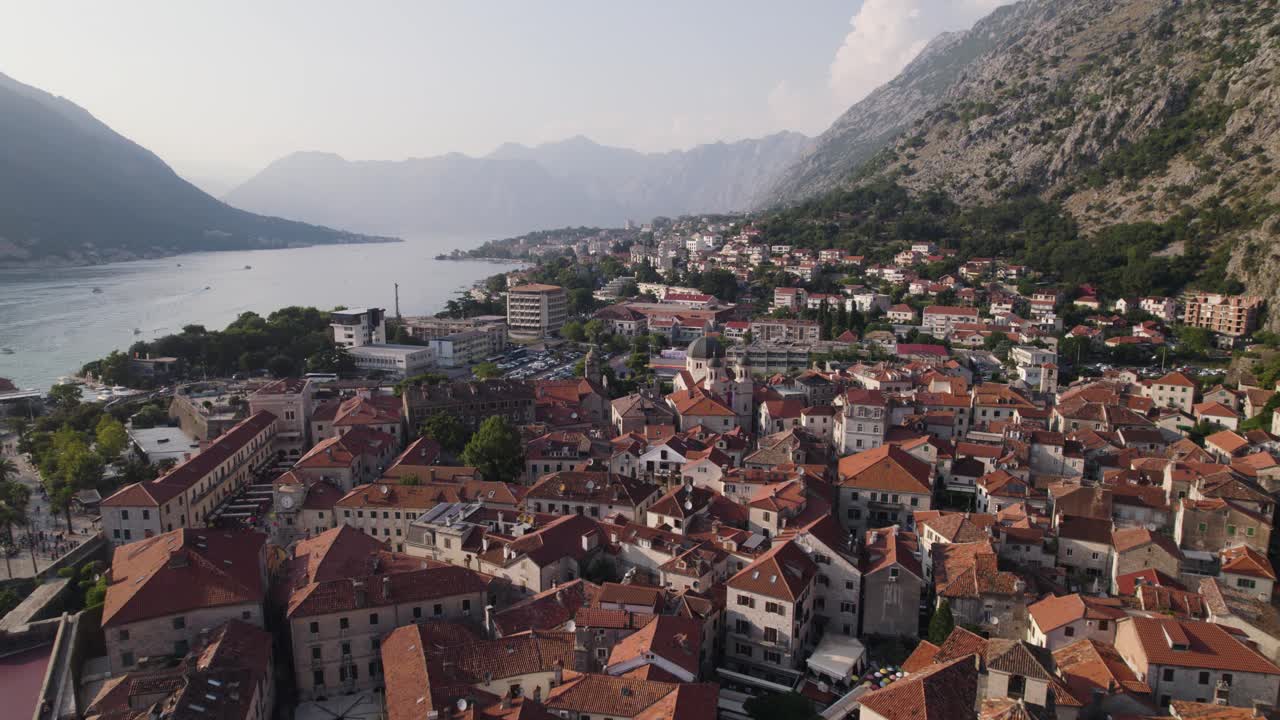 Stunning flyover aerial of city of Kotor in Montenegro flying above rooftops