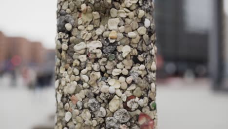 pillar covered with artistic mosaic of tiny different stones and pebbles, close up