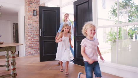 Young-white-family-arriving-back-to-their-home