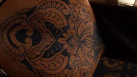 intricate floral back tattoo on woman