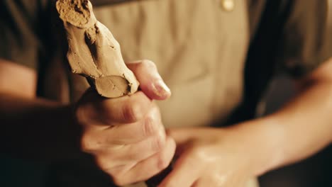 hands sculpting clay