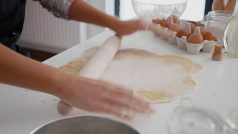 Close-up-of-children-hand-preparing-homemade-gingerbread-making-cookies-dough