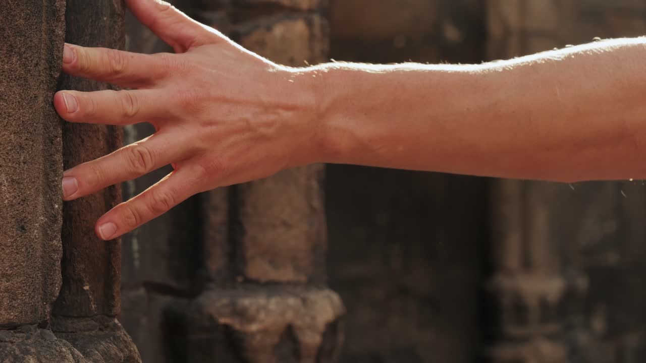 Touching old castle wall, Happy tourist man in Barcelona, Spain. Vacation exploring interesting places to travel, student vacation, young man portrait walking in gothic square, old european city