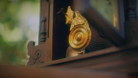 antique pendulum clock in a forest door open low angle close up pendulum shot slow motion