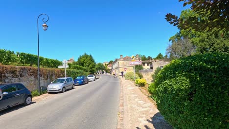 cyclist rides through scenic saint-émilion street